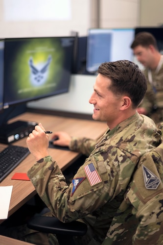Man in uniform at desk.
