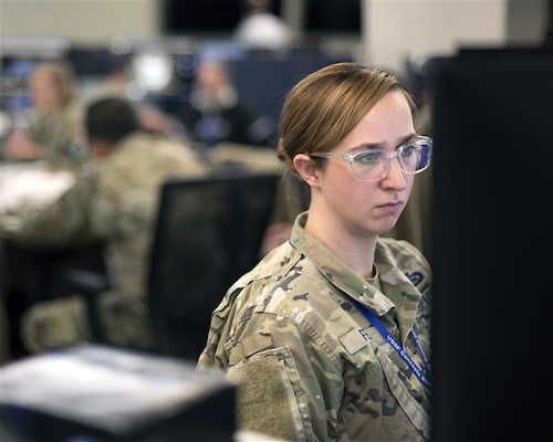 Woman in uniform typing at desk