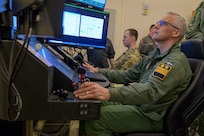 Swedish air force Maj. Gen. Jonas Wikman, chief of the Swedish air force, pilots an MQ-9 Reaper simulator during a visit to Hancock Field Air National Guard Base in Syracuse, NY, Apr. 7.
