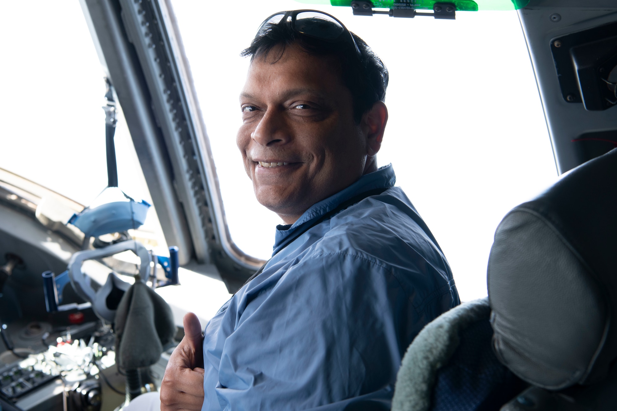 Spouse aboard flight smiling at the camera.