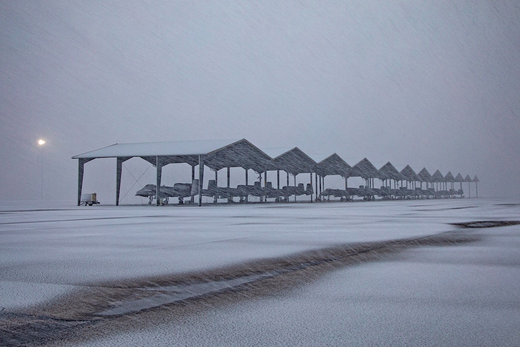 Snowcovered aircraft parked on flightline