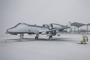 Snowcovered aircraft parked on flightline