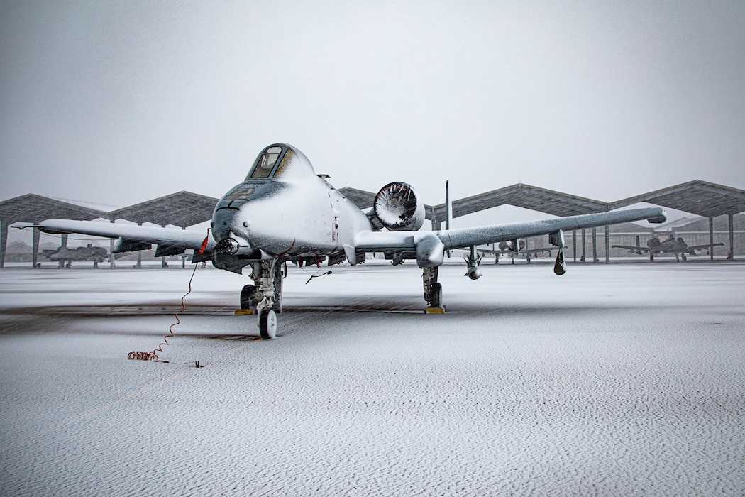 Snowcovered aircraft parked on flightline