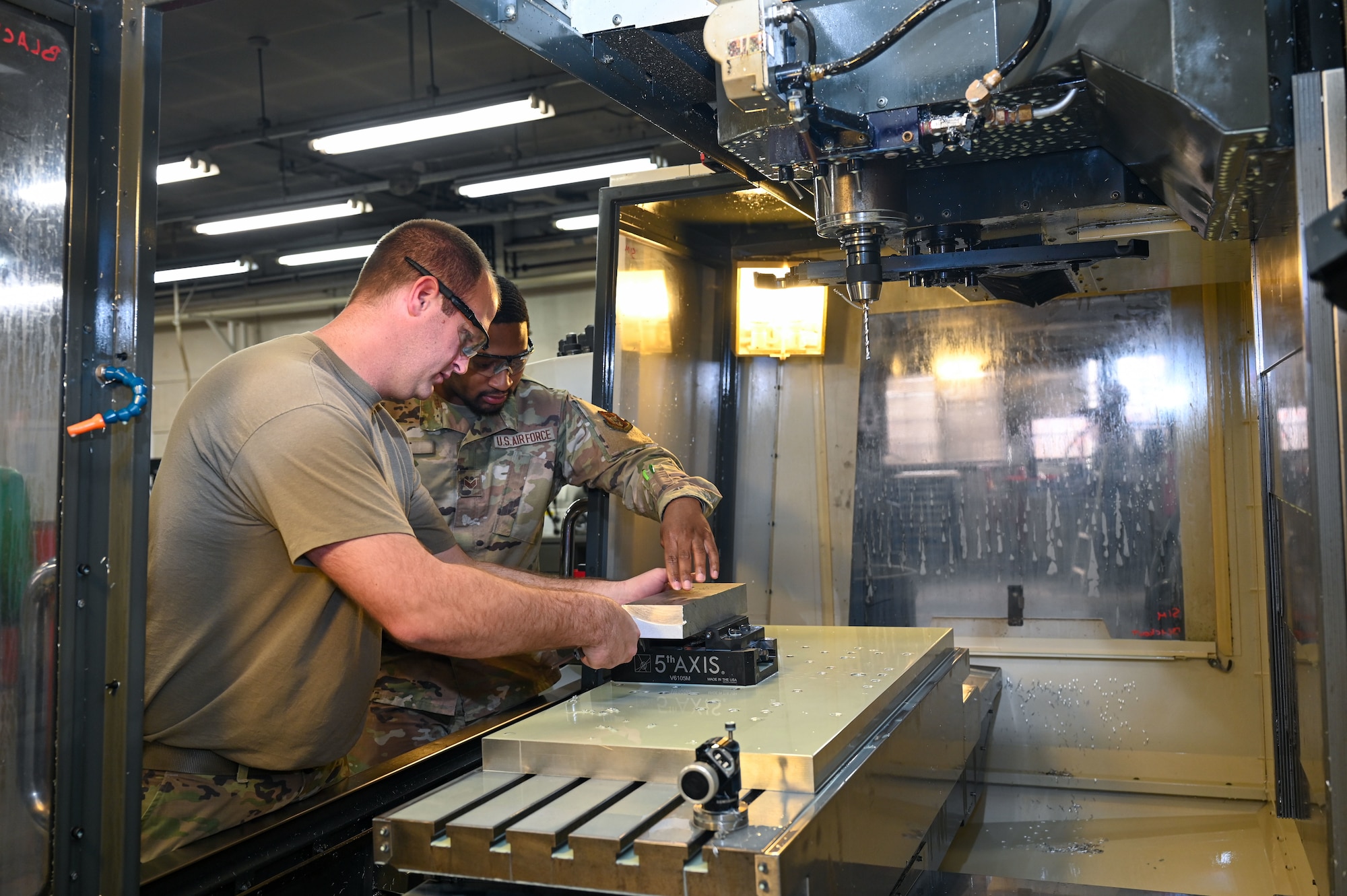 Airmen work on bracket