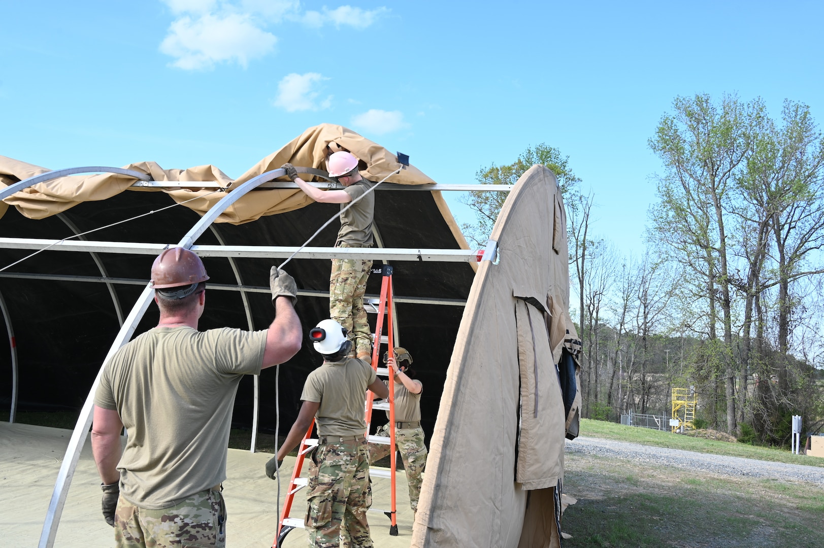 Airmen assigned to the 175th Wing, Maryland Air National Guard, construct a small shelter system at the 145th Regional Training Site in Badin, North Carolina, April 4, 2025.