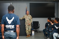 Chief Master Sgt. Israel Nuñez stands in front of trainees