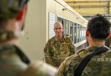 Lt Gen John Healy stands in front of Airmen