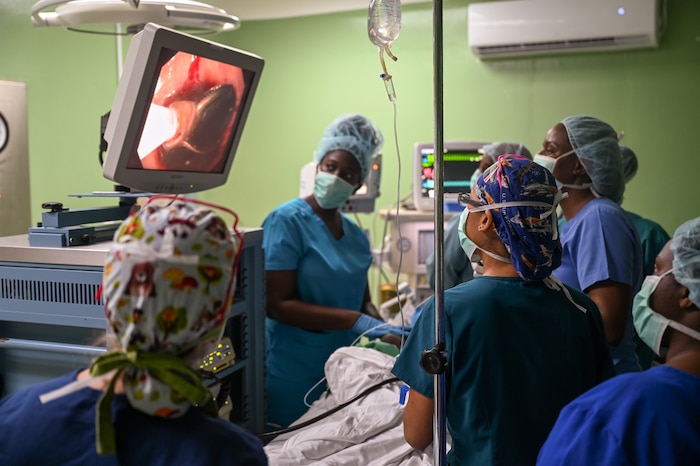 U.S. Air Force 1st Lt. Nicole Davidson (left), a 433rd Medical Squadron surgical nurse, and Staff Sgt. Daisy Victoria (center right), a 433rd Medical Squadron surgical technician, assist Dr. Natalie Osborne (right), a Kittitian general surgeon, during a surgical procedure to remove a coin lodged in a 3-year-old boy’s stomach at Joseph N. France General Hospital in Basseterre, St. Kitts and Nevis, March 27, 2025.
