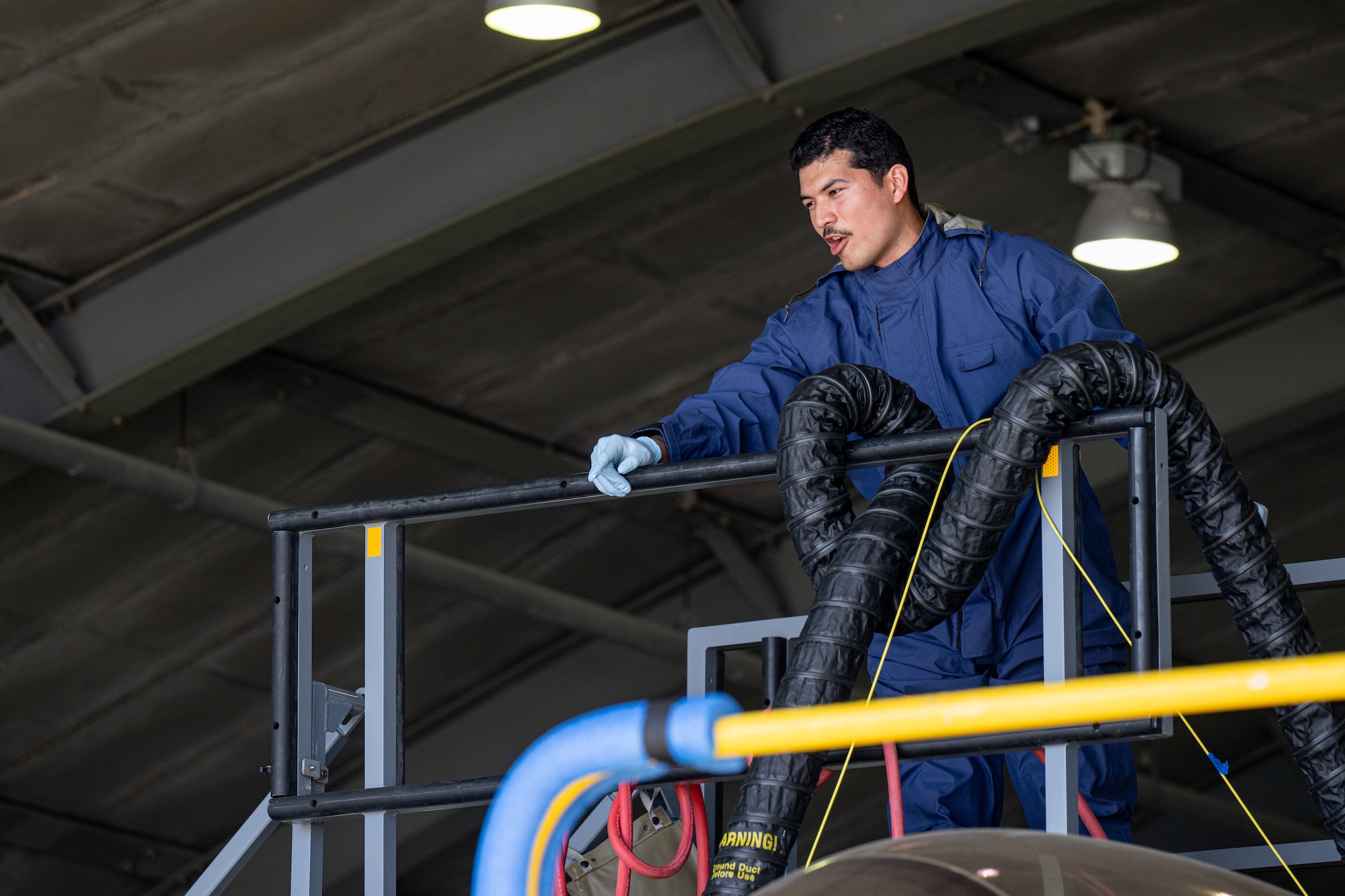An Airman alerts his coworkers of an unconscious teammate