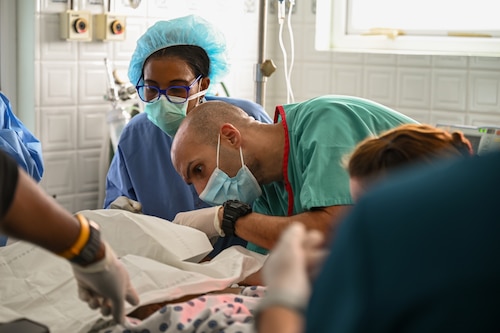 U.S. Air Force Maj. Mohammed Osman, 433rd Medical Squadron neurocritical care physician, works with a team of Nevisian and Air Force medical professionals to treat a three-month-old infant in the emergency room at Alexandria Hospital in St. Kitts and Nevis, March 28, 2025.