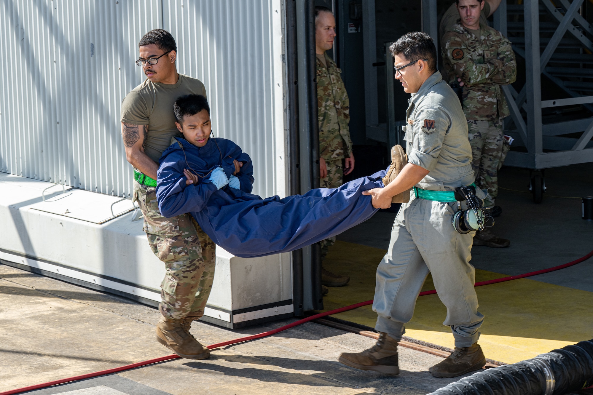 Airmen buddy carry a teammate to safety