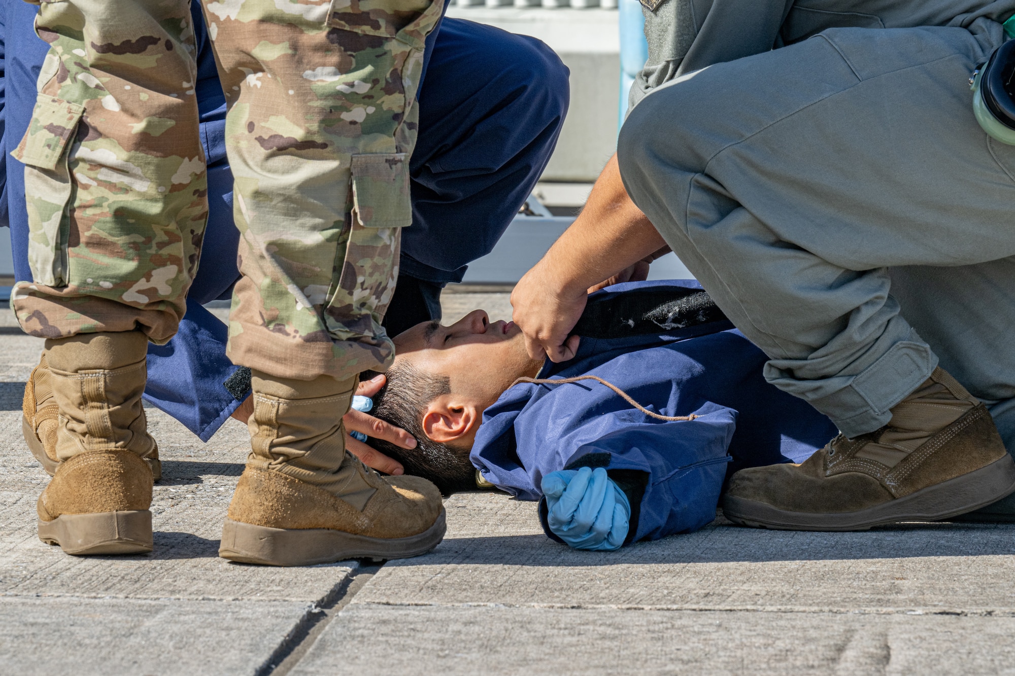 Airmen attend to an unconscious teammate