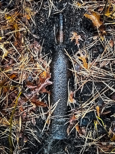 An MK II 75mm projectile is unearthed by unexploded ordnance contractors at Joint Base McGuire-Dix-Lakehurst, N.J., April 14, 2025. Recitation response escorts assigned to the U.S. Army’s 20th Chemical, Biological, Radiological, Nuclear, Explosives (CBRNE) Analytical and Remediation Activity (CARA) were tasked with the analysis and removal of the ordnance following its discovery at JB MDL. (U.S. Air Force courtesy photo)