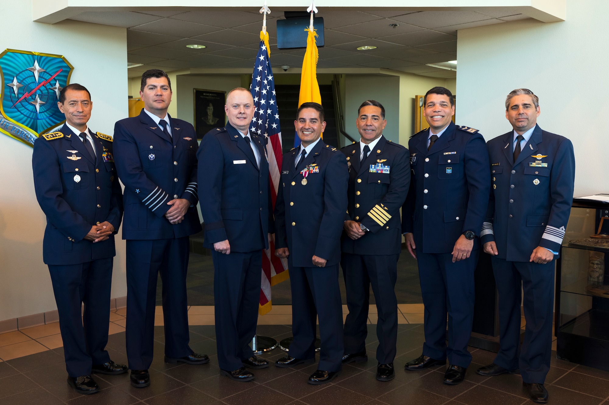 U.S. Air Force Brig. Gen. John Creel, Air Forces Southern deputy commander, center-left, poses for a group photo with Air Forces Southern foreign liaison officers at Davis-Monthan Air Force Base, Arizona, March 25, 2025. Foreign liaison officers serve as vital conduits between partner nations and U.S. military organizations, helping foster trust, enhance interoperability and coordinate joint efforts in pursuit of shared defense goals. (U.S. Air Force Photo by Tech. Sgt. Rachel Maxwell)