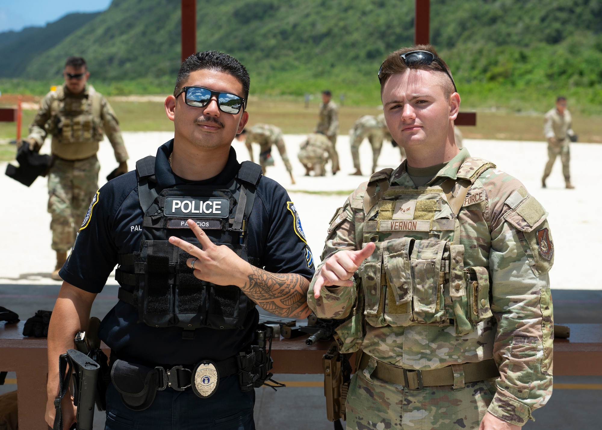 Christien Palacios, left, and U.S. Air Force Senior Airman Ayden Vernon, both 36th Security Forces Squadron team members, pose for a photo after training at Andersen Air Force Base, Guam, April 15, 2025. The training was held to hone communication and combat arms skills. (U.S. Air Force photo by Airman 1st Class Joseph Maye)