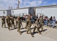 Hill Air Force Base Airmen wave to students during a military parade April 11, 2025, at Syracuse Junior High School in Syracuse, Utah. Active-duty military from Hill Air Force Base and local veterans participated in the parade, which aimed to celebrate military families during Month of the Military Child in April. (U.S. Air Force photo by Todd Cromar)
