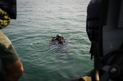 JINHAE NAVAL BASE, Republic of Korea (April 10, 2025) Navy Diver 1st Class Ernest Smith, assigned to Mobile Diving and Salvage Unit 1, resurfaces after completing a simulated salvage mission with a Republic of Korea navy diver, during a joint dive and salvage exercise in the harbor of Jinhae Naval Base, Republic of Korea, April 10, 2025. Commander, Logistics Group Western Pacific/Task Force 73 sustains the U.S. Navy’s maritime forces and is responsible for all diving and salvage operations in the Western Pacific in support of a free and open Indo-Pacific.