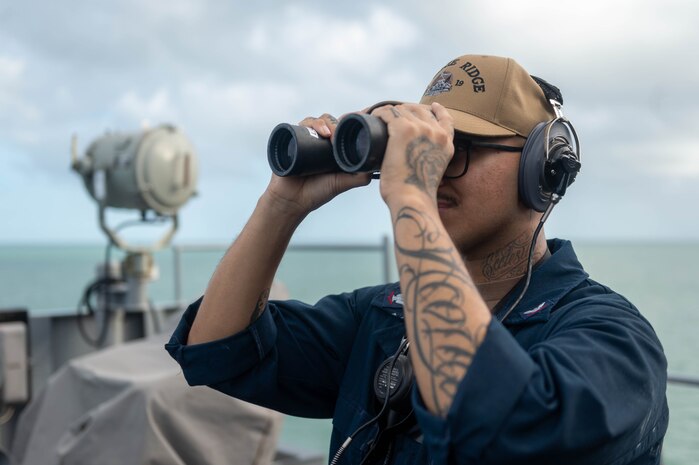 250416-N-TU814-1042
CAIRNS, Australia (April 16, 2025) – Operations Specialist 3rd Class Angel Acosta, from San Antonio, stands watch on the bridge of the U.S. 7th Fleet flagship USS Blue Ridge (LCC 19) prior to arriving to Cairns, Australia, for a scheduled port visit, April 16, 2025. The Blue Ridge and embarked U.S. 7th Fleet staff conduct regular Indo-Pacific patrols to deter aggression, strengthen alliances and partnerships, and advance future warfighting capabilities. (U.S. Navy photo by Mass Communication Specialist Seaman Damian Cook)