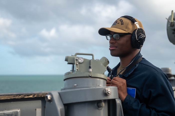 250416-N-TU814-1040
CAIRNS, Australia (April 16, 2025) - Quartermaster Seaman Randy Lawrence stands watch on the bridge of the U.S. 7th Fleet flagship USS Blue Ridge (LCC 19) prior to arriving to Cairns, Australia, for a scheduled port visit, April 16, 2025. The Blue Ridge and embarked U.S. 7th Fleet staff conduct regular Indo-Pacific patrols to deter aggression, strengthen alliances and partnerships, and advance future warfighting capabilities. (U.S. Navy photo by Mass Communication Specialist Seaman Damian Cook)