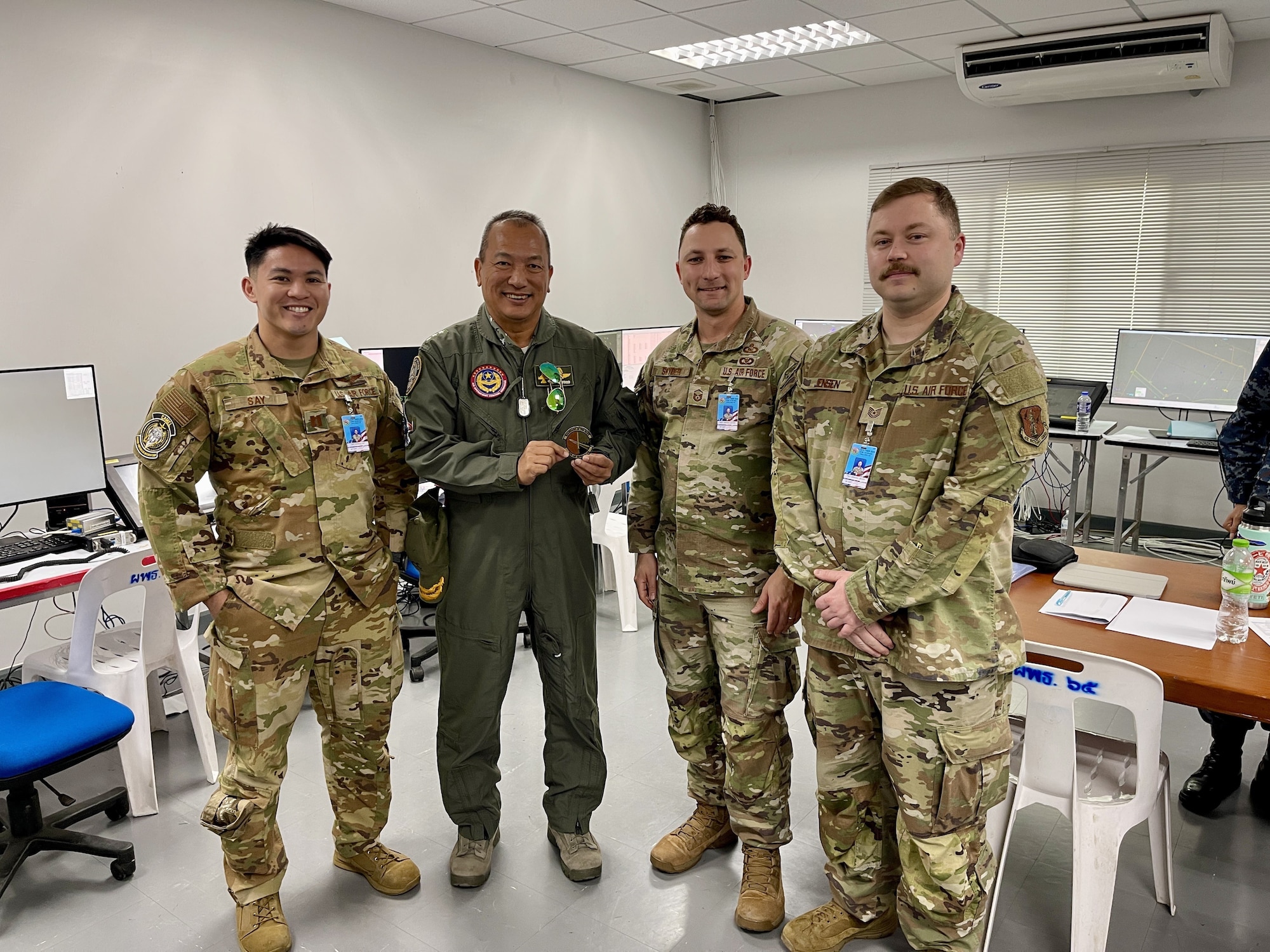 Royal Thai Air Force Air Chief Marshal Rawin Thanomsingh receives a squadron patch.