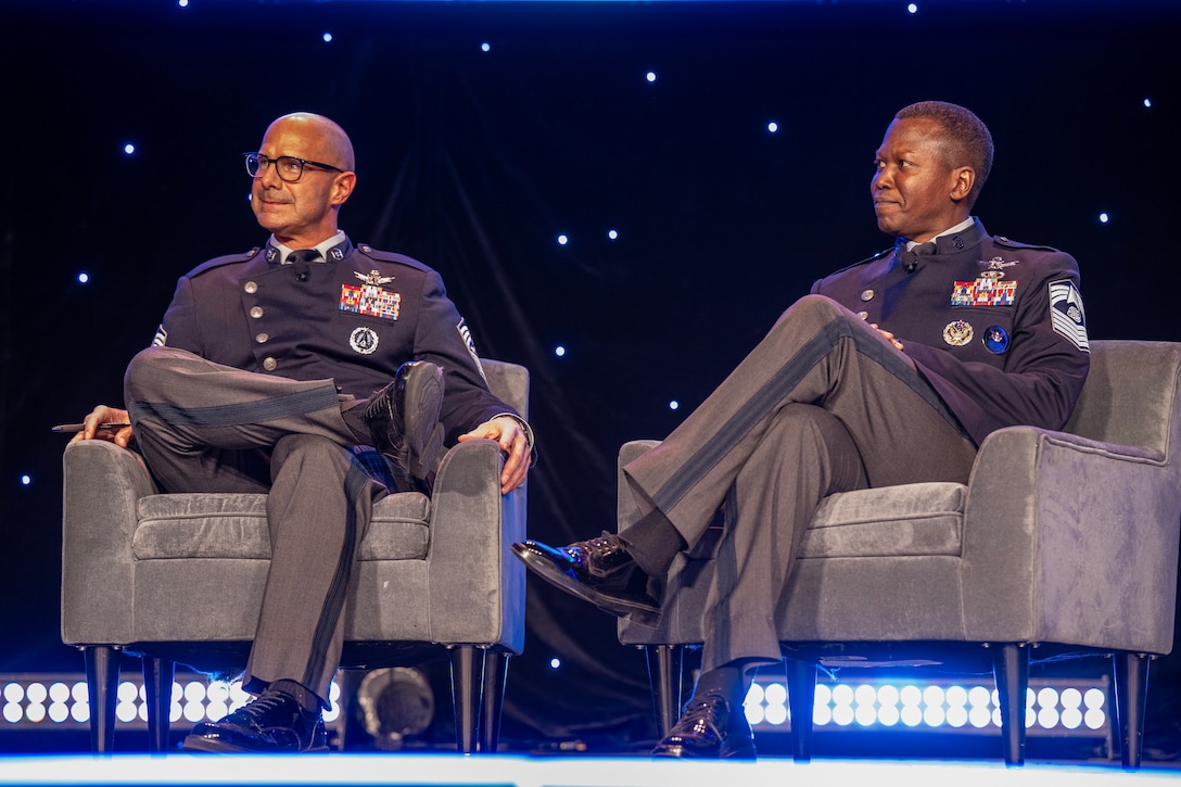 Two military members speak at a symposium.
