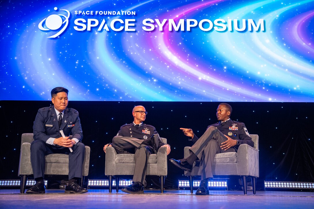 Military members speak at a symposium.