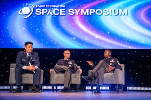 Military members speak at a symposium.