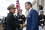 Two men shake hands at the Pentagon.