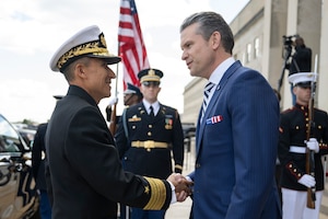 Two men shake hands at the Pentagon.