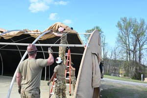 Airmen assigned to the 175th Wing, Maryland Air National Guard, construct a small shelter system at the 145th Regional Training Site in Badin, North Carolina, April 4, 2025.