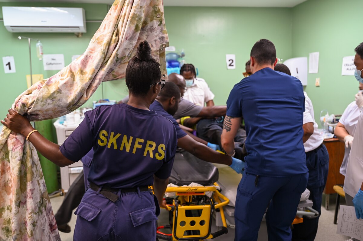 U.S. Air Force Capt. Thomas Murph, 433rd Medical Squadron emergency room nurse, assists Kittitian first responders at Joseph N. France General Hospital in Basseterre, St. Kitts and Nevis to move a man injured after a fall April 1, 2025.