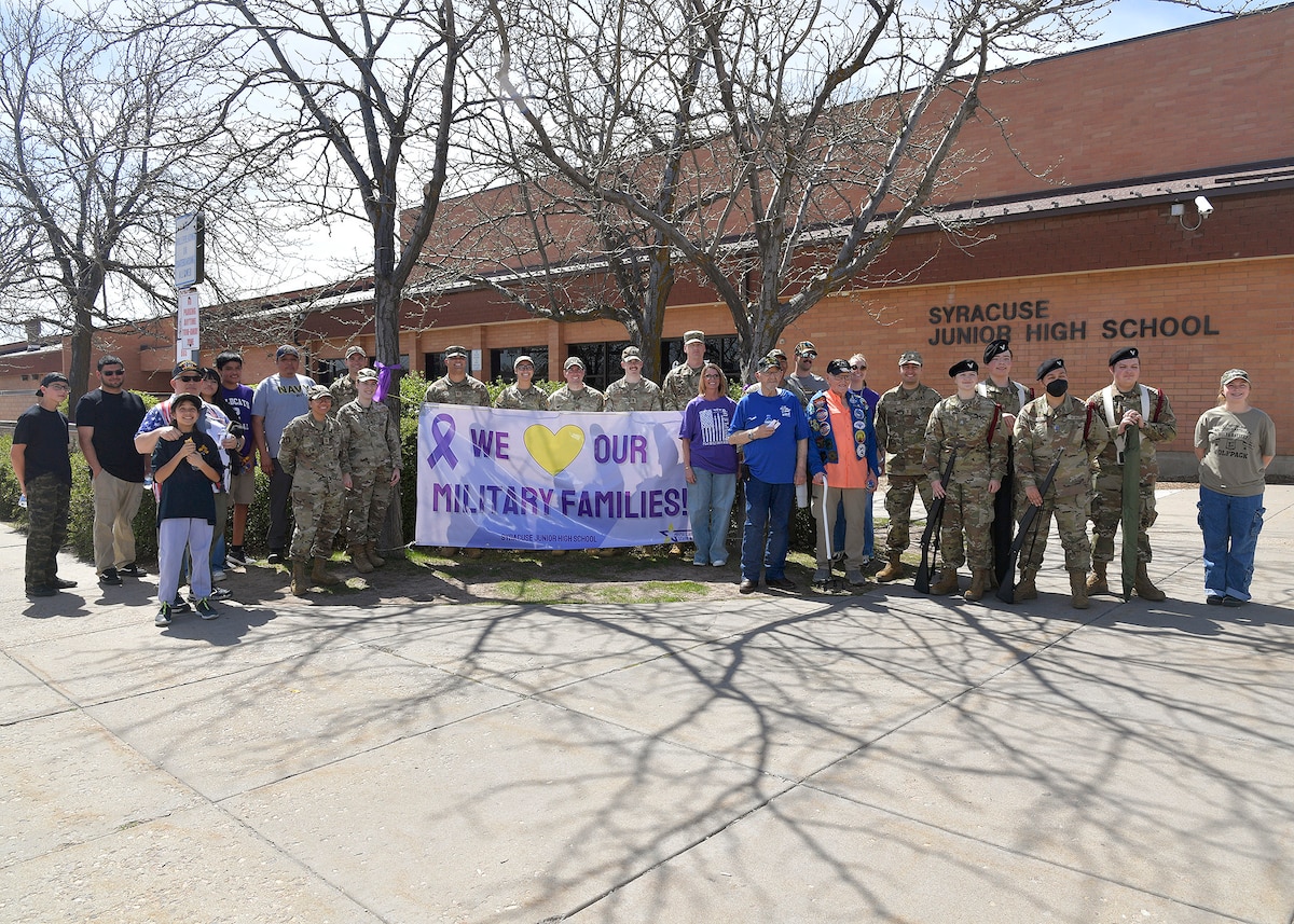 Hill Air Force Base Airmen, community veterans, Northridge High School Honor Guard members, and Syracuse Junior High School faculty pose for a group photo April 11, 2025, at Syracuse Junior High School in Syracuse, Utah. Active-duty military from Hill AFB and local veterans participated in the parade, which aimed to celebrate military families during Month of the Military Child in April. (U.S. Air Force photo by Todd Cromar)