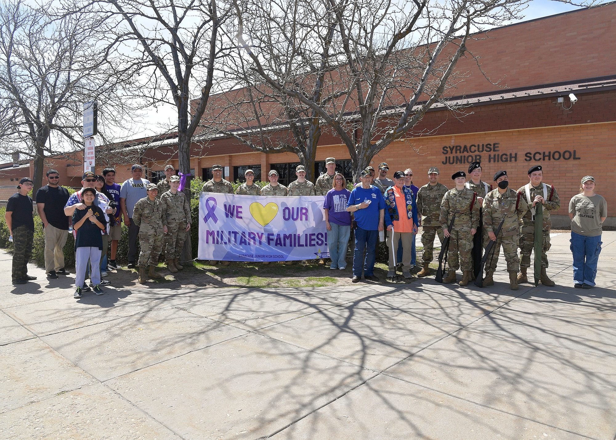 Hill Air Force Base Airmen, community veterans, Northridge High School Honor Guard members, and Syracuse Junior High School faculty pose for a group photo April 11, 2025, at Syracuse Junior High School in Syracuse, Utah. Active-duty military from Hill AFB and local veterans participated in the parade, which aimed to celebrate military families during Month of the Military Child in April. (U.S. Air Force photo by Todd Cromar)