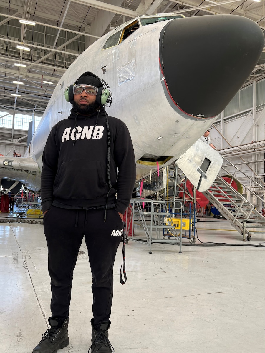 Man standing in front of airplane