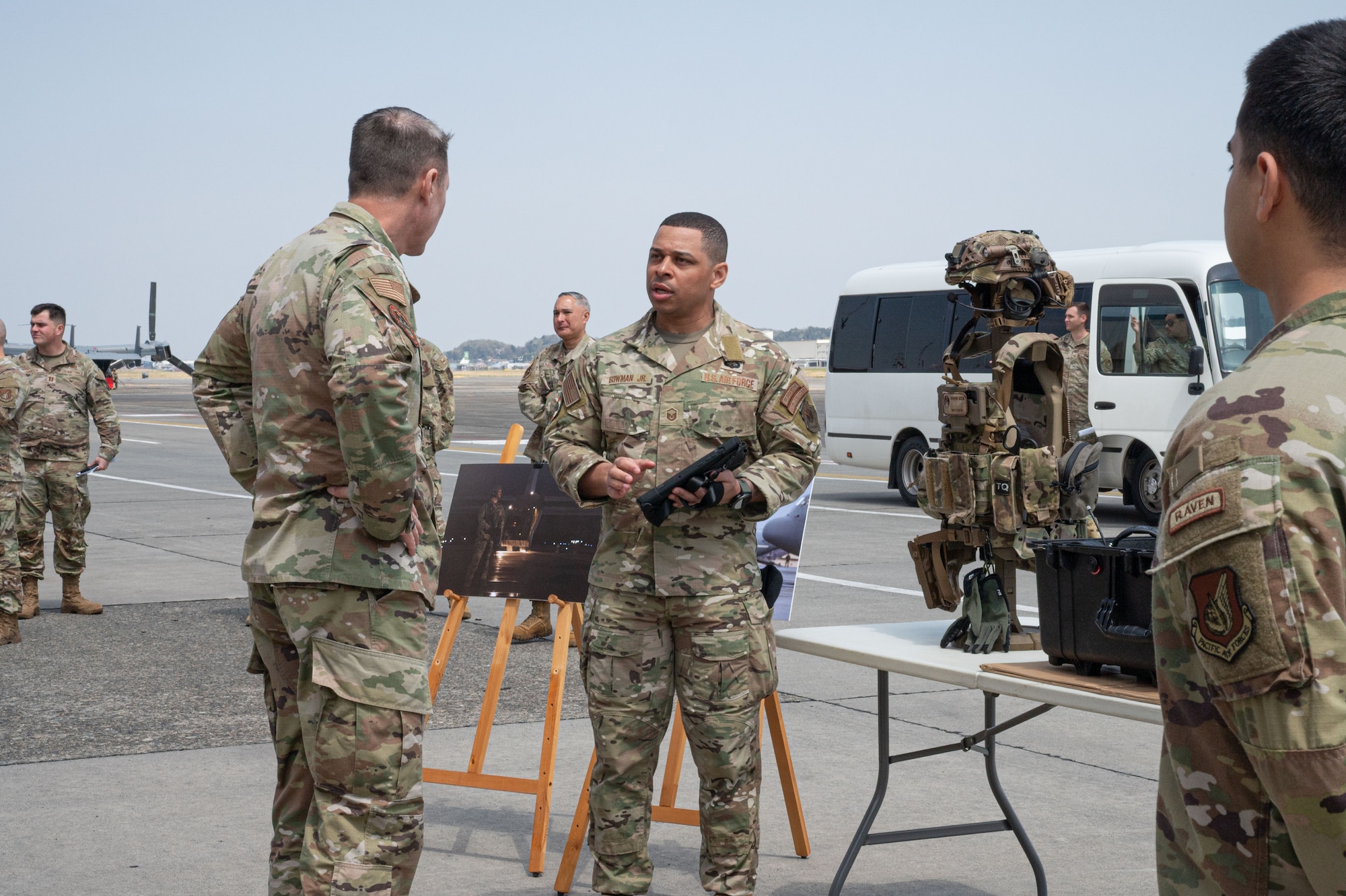 Service members speak in front of a display