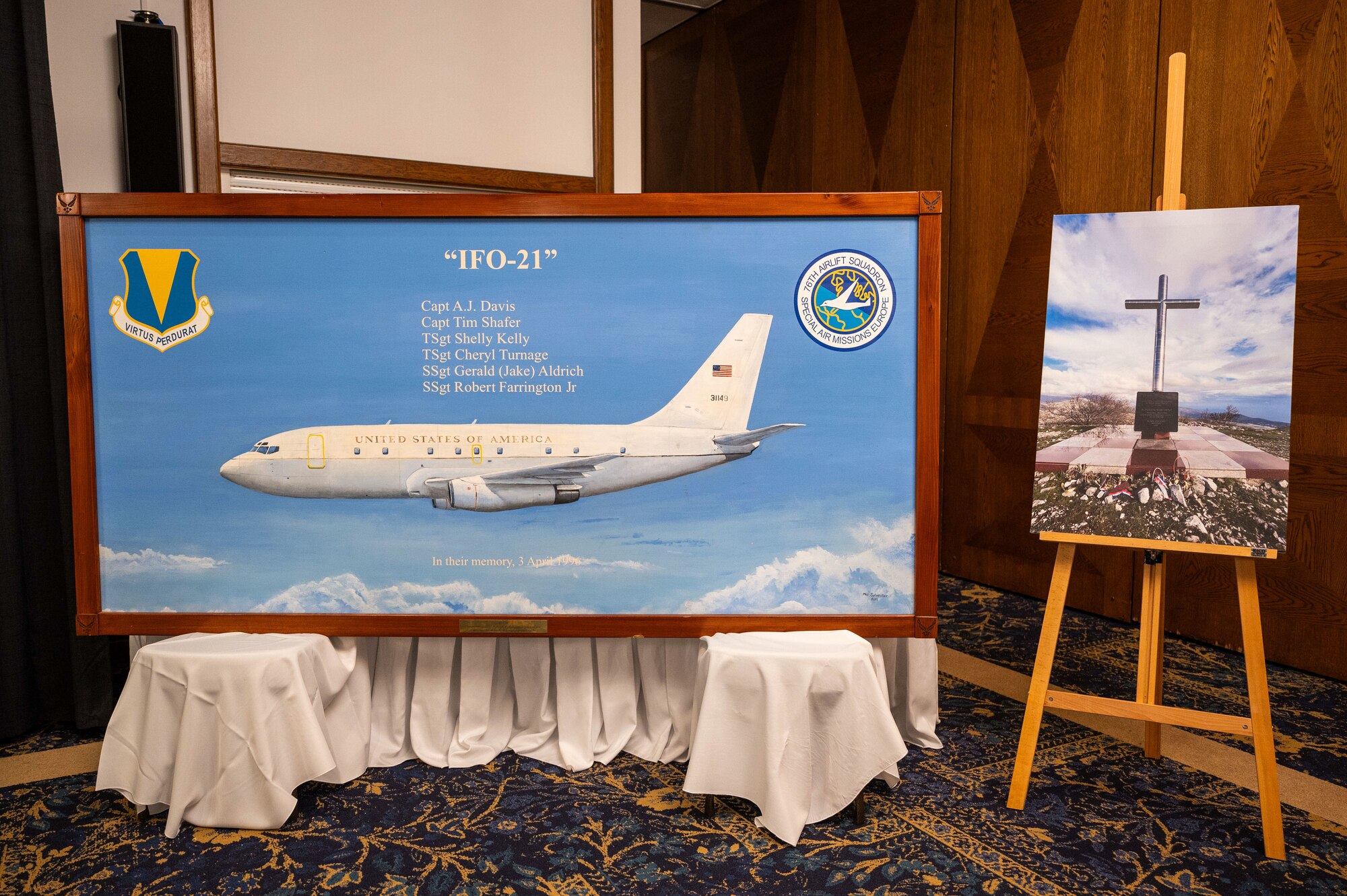 The 76th Airlift Squadron hosts a remembrance ceremony honoring the crew of Implementation Force-21 at Ramstein Air Base, Germany, April 10, 2025. The sign listed the names of the six U.S. Airmen who passed away in the IFO-21 crash: Capt A.J. Davis, Capt. Tim Shafer, Tech. Sgt. Shelly Kelly, Tech. Sgt. Cheryl Turnage, Staff Sgt. Gerald Aldrich, and Staff Sgt. Robert Farrington Jr., all members of the 76th Airlift Squadron.