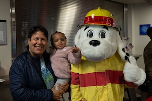 Adaptive Field Day participants pose for a photo with Sparky the Fire Dog.