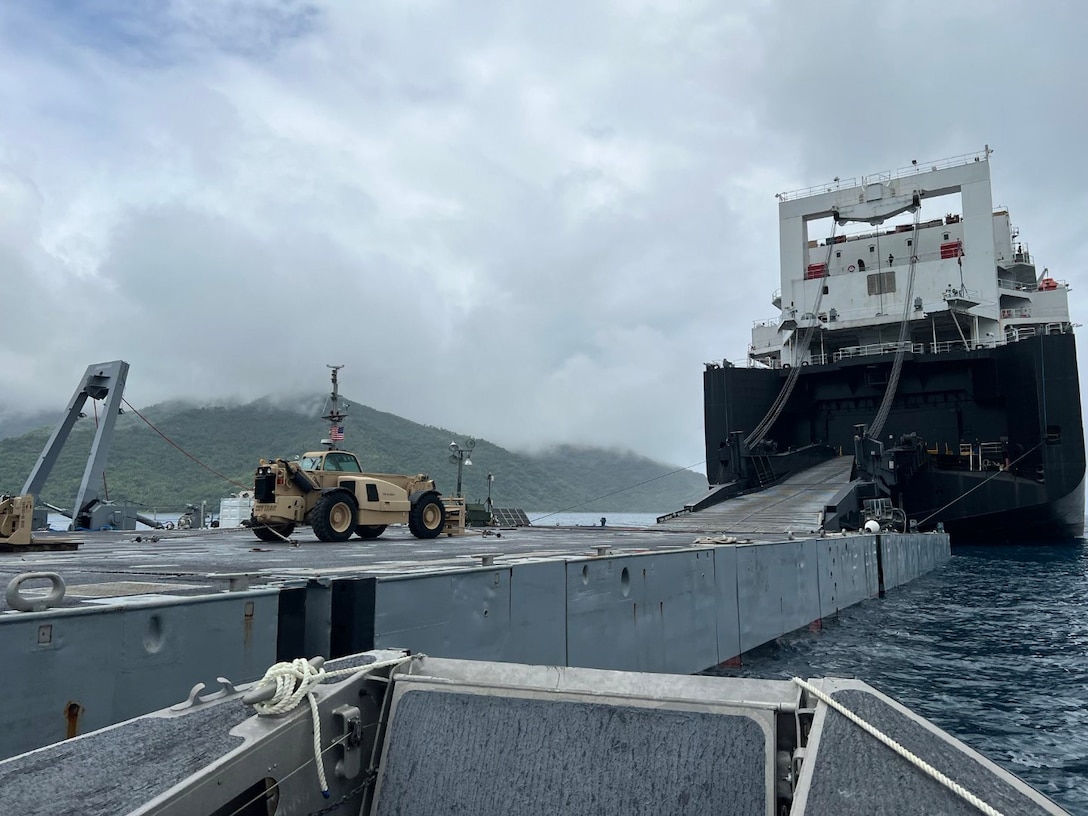 U.S. Marines from 3rd Marine Division work with a technical advisory and assistance team from Blount Island Command during an in-stream offload from the USNS Sisler, a cargo ship operated by Military Sealift Command, April 3 at Dingalan Bay in the Philippines. The equipment, sent from Marine Corps Support Facility Blount Island in Jacksonville, Florida, the hub of Marine Corps’ prepositioning programs, will support Marines participating in Exercise Balikatan 25, which kicks off April 21. Balikatan is a longstanding annual exercise between the Philippines and U.S. armed forces. (Official U.S. Marine Corps photo/Col. Luke Watson)