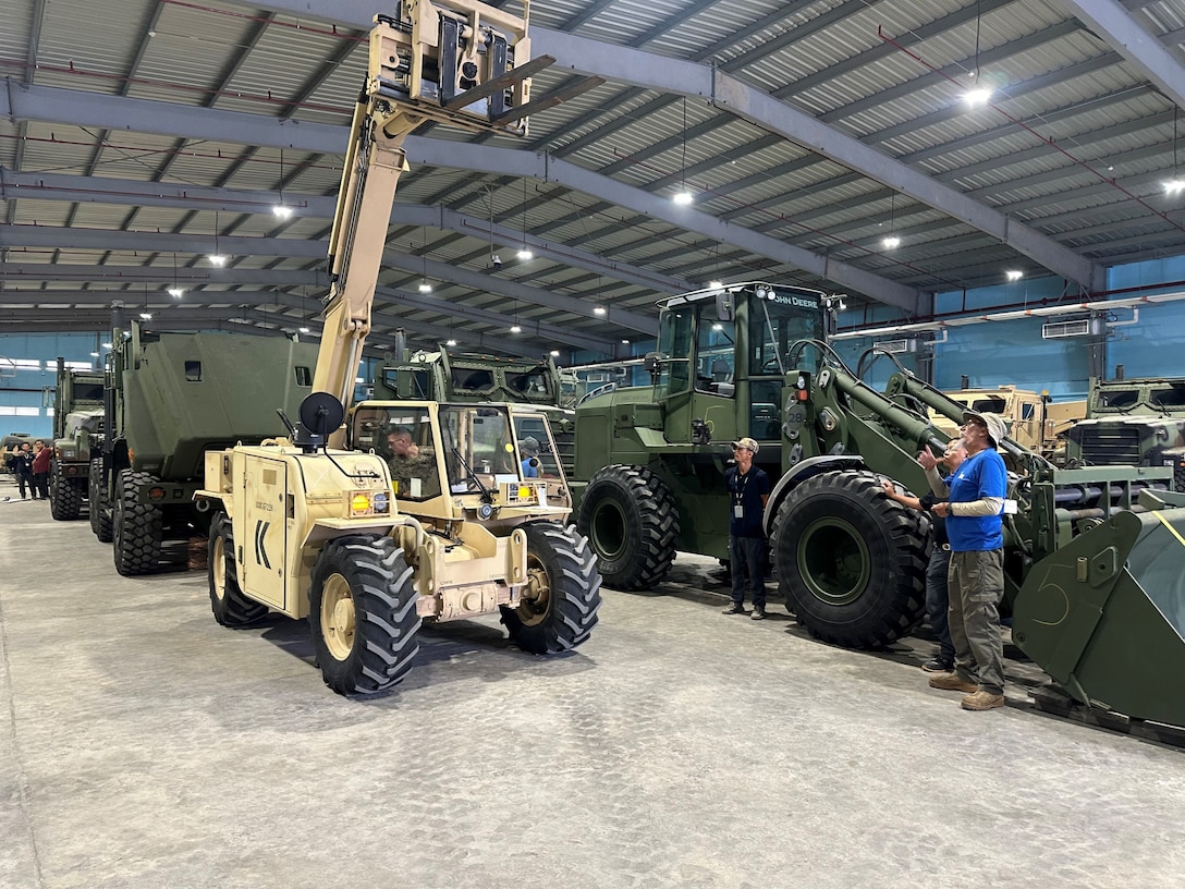 U.S. Marines with 3rd Marine Littoral Regiment, 3rd Marine Division, work with a technical advisory and assistance team from Blount Island Command during equipment inspections April 8 at a joint theater distribution center in the Philippines. The equipment, sent from Marine Corps Support Facility Blount Island in Jacksonville, Florida, the hub of Marine Corps’ prepositioning programs, will support Marines participating in Exercise Balikatan 25, which kicks off April 21. Balikatan is a longstanding annual exercise between the Philippines and U.S. armed forces. (Official U.S. Marine Corps photo/Jason Hazard)