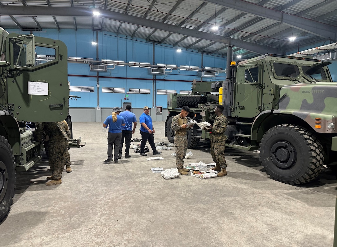 U.S. Marines with 3rd Marine Littoral Regiment, 3rd Marine Division, work with a technical advisory and assistance team from Blount Island Command during equipment inspections April 8 at a joint theater distribution center in the Philippines. The equipment, sent from Marine Corps Support Facility Blount Island in Jacksonville, Florida, the hub of Marine Corps’ prepositioning programs, will support Marines participating in Exercise Balikatan 25, which kicks off April 21. Balikatan is a longstanding annual exercise between the Philippines and U.S. armed forces. (Official U.S. Marine Corps photo/Jason Hazard)