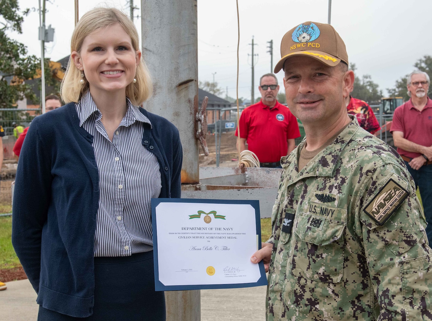 Ms. Anna Belle Tiller, NSWC PCD contracting officer, is presented the Dept. of the U.S. Navy's Civilian Service Achievement Medal by Capt. Paul Stence, Jr., NSWC PCD commanding officer, March 14. Her actions to ensure the fleet can continue receiving in-service engineering agent support on the unmanned surface vehicles being deployed as part of the mine countermeasure mission package on littoral combat ships resulted in cost savings of nearly $80M. (U.S. Navy photo by Eddie Green)