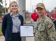 Ms. Anna Belle Tiller, NSWC PCD contracting officer, is presented the Dept. of the U.S. Navy's Civilian Service Achievement Medal by Capt. Paul Stence, Jr., NSWC PCD commanding officer, March 14. Her actions to ensure the fleet can continue receiving in-service engineering agent support on the unmanned surface vehicles being deployed as part of the mine countermeasure mission package on littoral combat ships resulted in cost savings of nearly $80M. (U.S. Navy photo by Eddie Green)