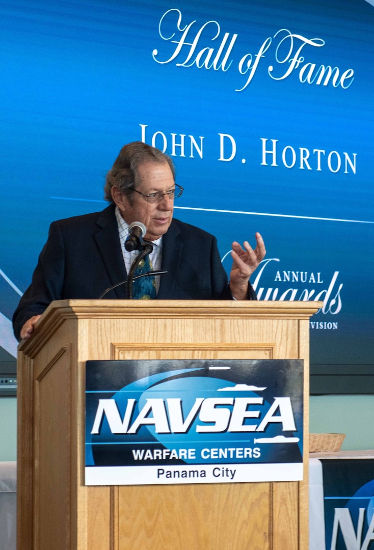 John Horton addresses the crowd during his FY24 NSWC PCD Hall of Fame Award selection speech, March 27, 2025. Horton provided words of wisdom and emphasized the importance of mentorship and being mentored. (U.S. Navy photo by Eddie Green)