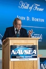 John Horton addresses the crowd during his FY24 NSWC PCD Hall of Fame Award selection speech, March 27, 2025. Horton provided words of wisdom and emphasized the importance of mentorship and being mentored. (U.S. Navy photo by Eddie Green)