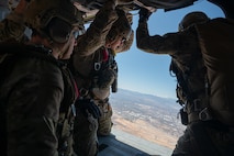 Three U.S. Air Force pararescuemen assigned to the 88th Test and Evaluation Squadron prepare to jump from an HH-60W Jolly Green II for a Combat Arms Demonstration (CAD) during Aviation Nation Air Show 2025 at Nellis Air Force Base, Nevada, April 5, 2025.