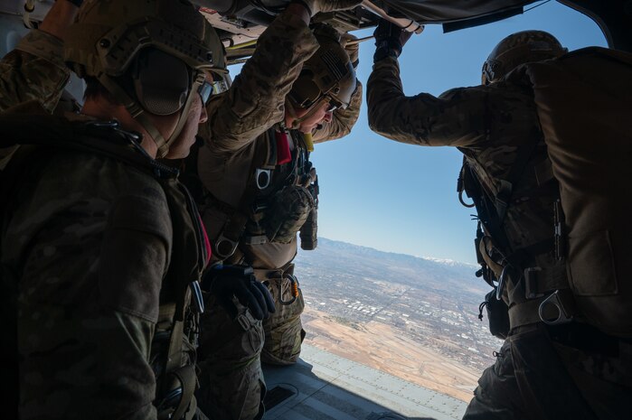 Three U.S. Air Force pararescuemen assigned to the 88th Test and Evaluation Squadron prepare to jump from an HH-60W Jolly Green II for a Combat Arms Demonstration (CAD) during Aviation Nation Air Show 2025 at Nellis Air Force Base, Nevada, April 5, 2025.