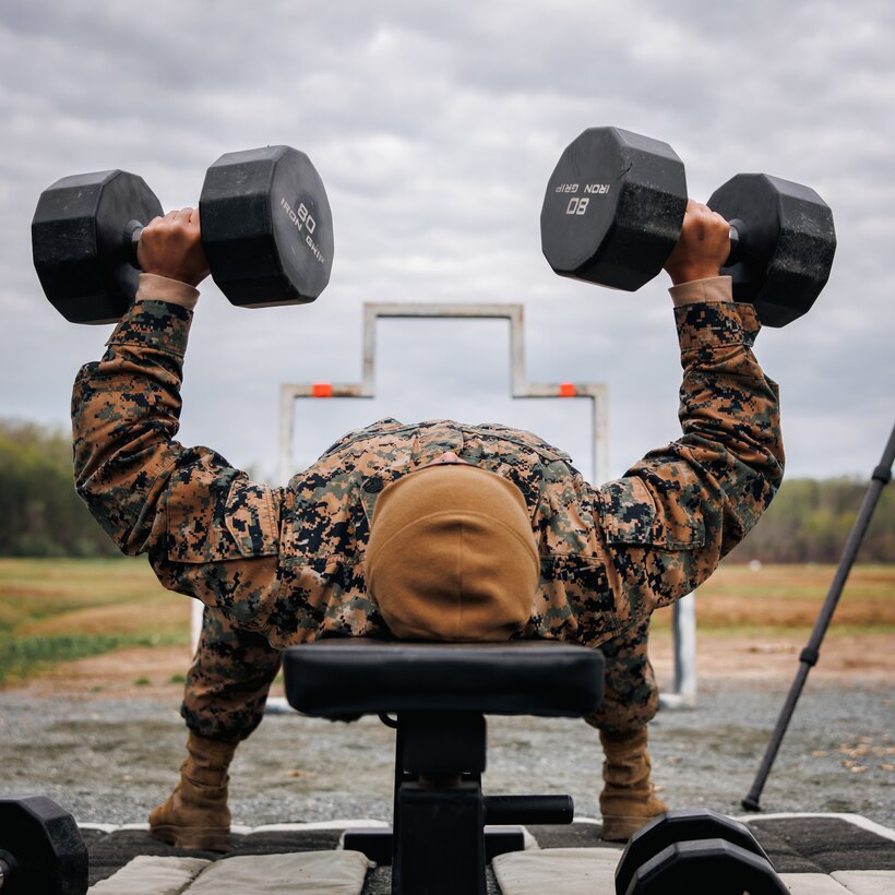 U.S. Marine Corps Staff Sgt. Seyha Lek, a motor transport instructor with Marine Corps Detachment Training Command Fort Leonard Wood, conducts a bench press as part of a shooting drill during the Marine Corps Marksmanship Championships individual rifle match, hosted by Weapons Training Battalion at Marine Corps Base Quantico, Virginia, April 14, 2025. The competition brings together the top shooters from regional Marine Corps Marksmanship Competitions to test their skills in precision rifle, action pistol, and multi-gun shooting. It continues the legacy of the Marine Corps shooting team, which has upheld marksmanship excellence since the early 1900’s and reinforces the Corps’ commitment to marksmanship as a core warfighting skill. (U.S. Marine Corps photo by Lance Cpl. Braydon Rogers)