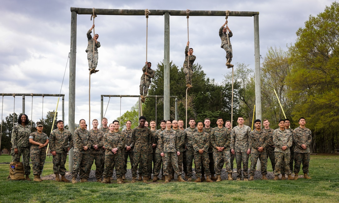 U.S. Marines with Security Battalion pose for a group photo after completing an obstacle course PT on Marine Corps Base Quantico, April 16, 2025. Security Battalion hosted this PT event in order to foster Espirit de Corps. (U.S. Marine Corps photo by Lance Cpl. Jeffery Stevens)