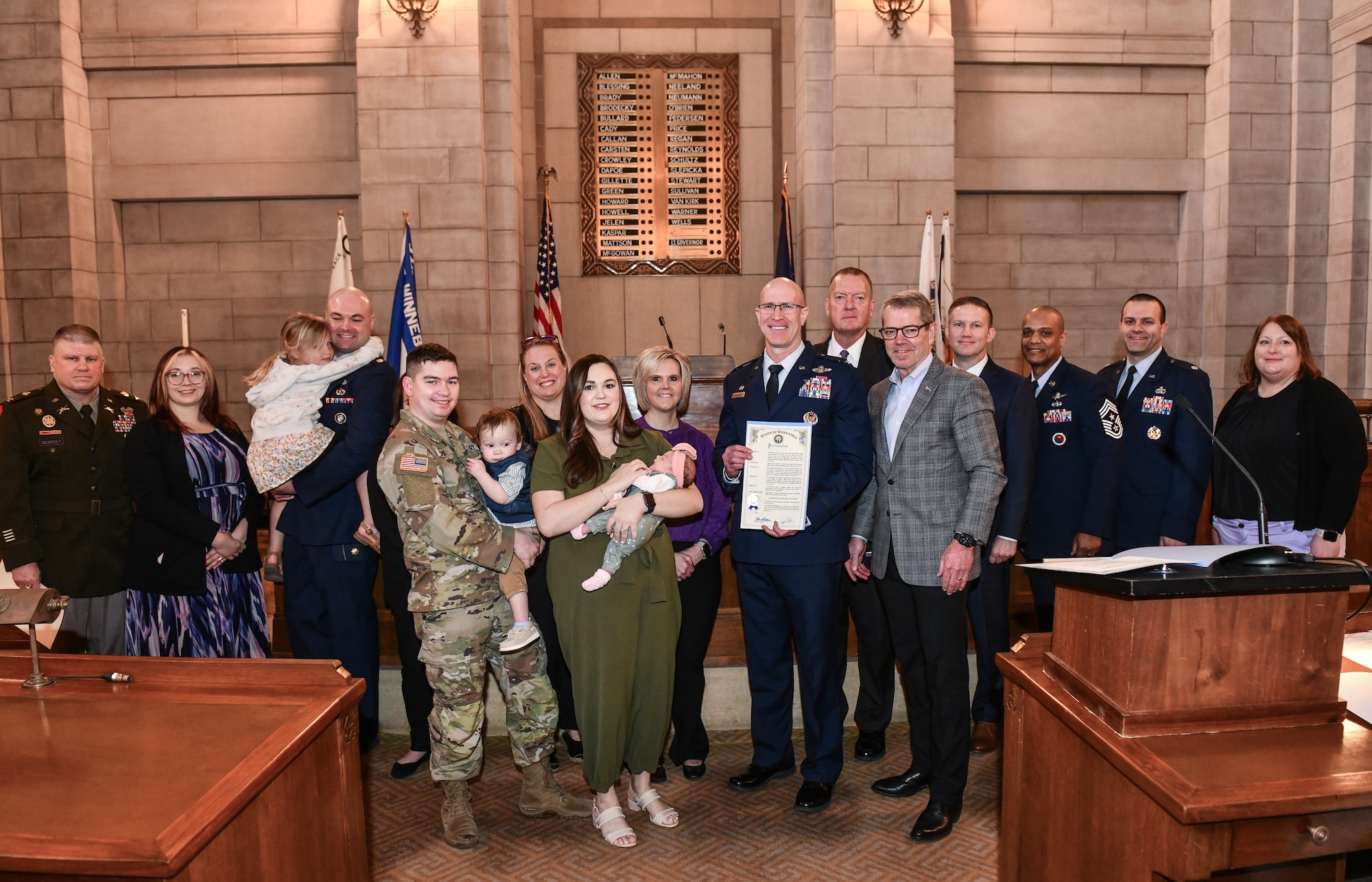 Col. Mark Howard, 55th Wing commander, and Gov. Jim Pillen stand with military members after the signing of the Month of the Military Child proclamation in Lincoln, April 10, 2025.(U.S. Air Force photo by Chad Watkins)