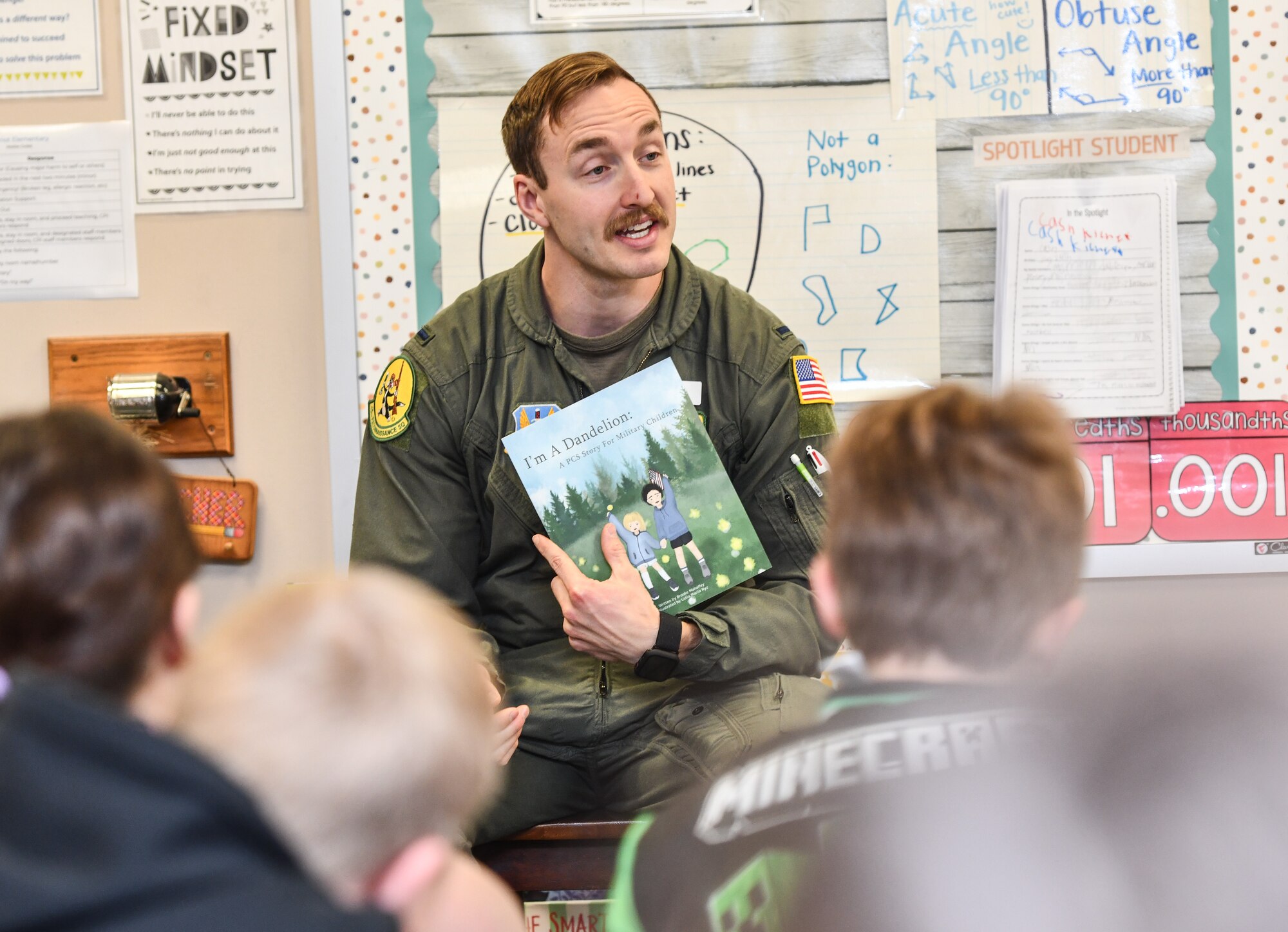 1st Lt. Jake Steuben, 45th Reconnaissance Squadron navigator, reads to Ms. Keefer's 4th grade class at Patriot Elementary in La Vista, Nebraska, April 16, 2025. The event was part of the Month of the Military Child celebration, where service members read to school children. (U.S. Air Force photo by Chad Watkins)